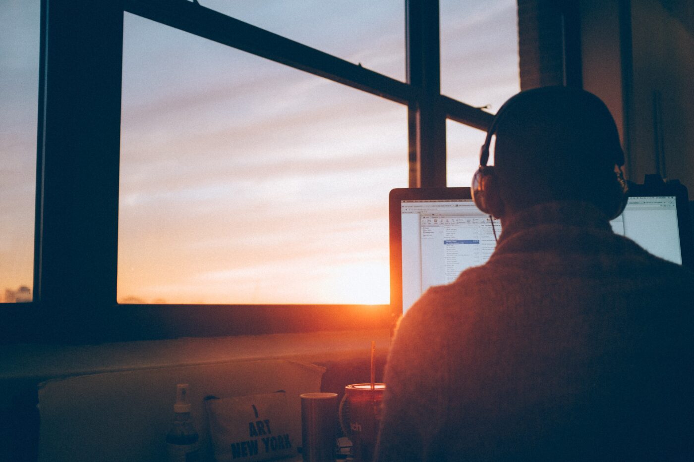 Man works on computer at sunset